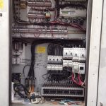 A large electrical panel filled with wires and various electrical components, showcasing intricate connections and equipment.