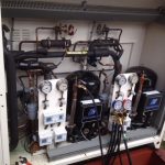 Air conditioning unit positioned next to another air conditioning unit, showcasing their design and functionality in a room.