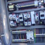 A panel displaying various electrical equipment and interconnected wires, showcasing a complex wiring system.