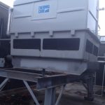 A large industrial air conditioner mounted on a sturdy metal stand, designed for efficient cooling in commercial spaces.