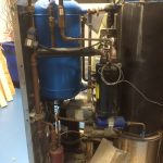 A large industrial water heater featuring interconnected pipes and valves, showcasing its robust design and functionality.
