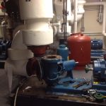 A room showcasing various pumps and valves, highlighting their diverse designs and functionalities in a technical setting.