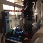 A spacious industrial room featuring numerous pipes and valves, showcasing a complex network of machinery and infrastructure.